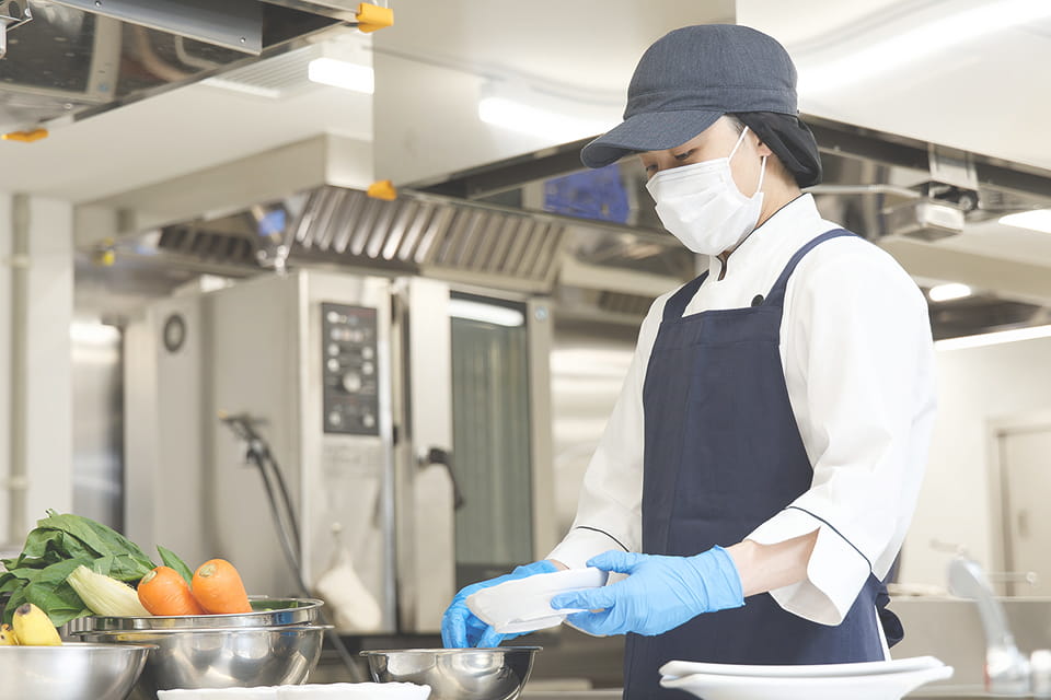 割烹姿で調理をする女性